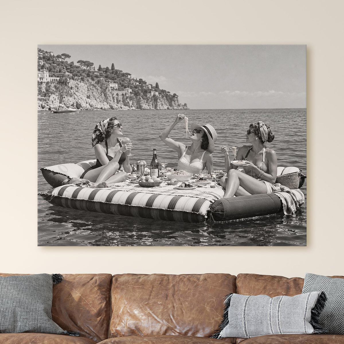 Floating Luncheon, three young women eat spaghetti on inflatable mattresses
