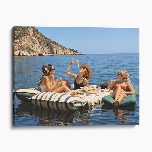 Floating Luncheon, Three Young Women Eat Spaghetti on Inflatable Mattresses