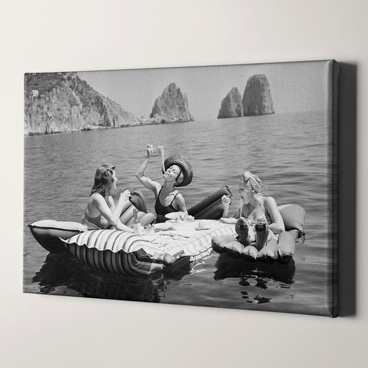 Floating Luncheon, three young women eat spaghetti on inflatable mattresses at Lake of Capri, 1939